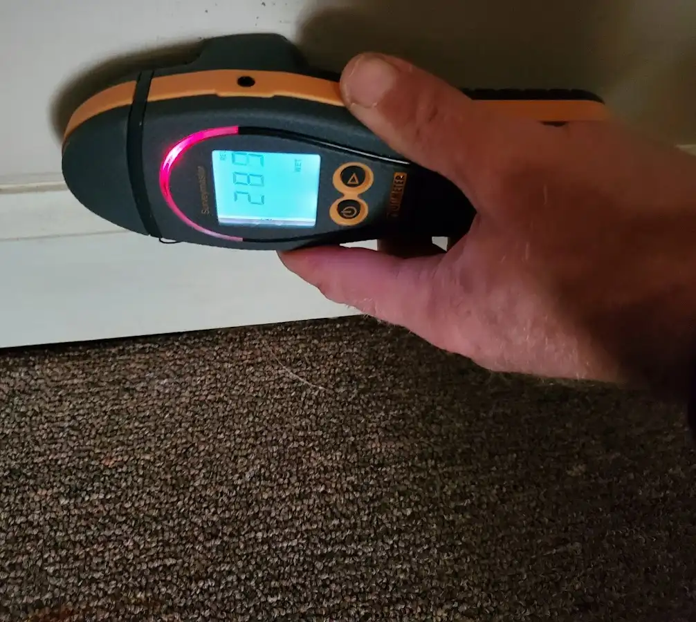 Moisture detection at baseboard during Storm Damage Restoration in West Slope